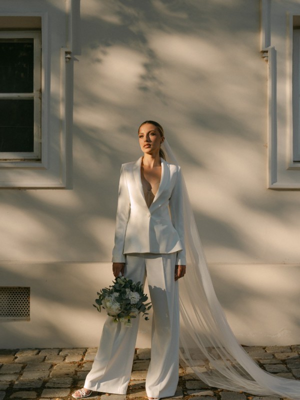 Eleganter Hosenanzug für die Hochzeit mit tailliertem Blazer und langem Schleier für einen modernen und stilvollen Brautlook