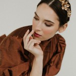 Model trägt den goldenen Haarreif 'Tara' mit Perlen und Blüten, stilvoller Haarschmuck für besondere Anlässe. thumbnail